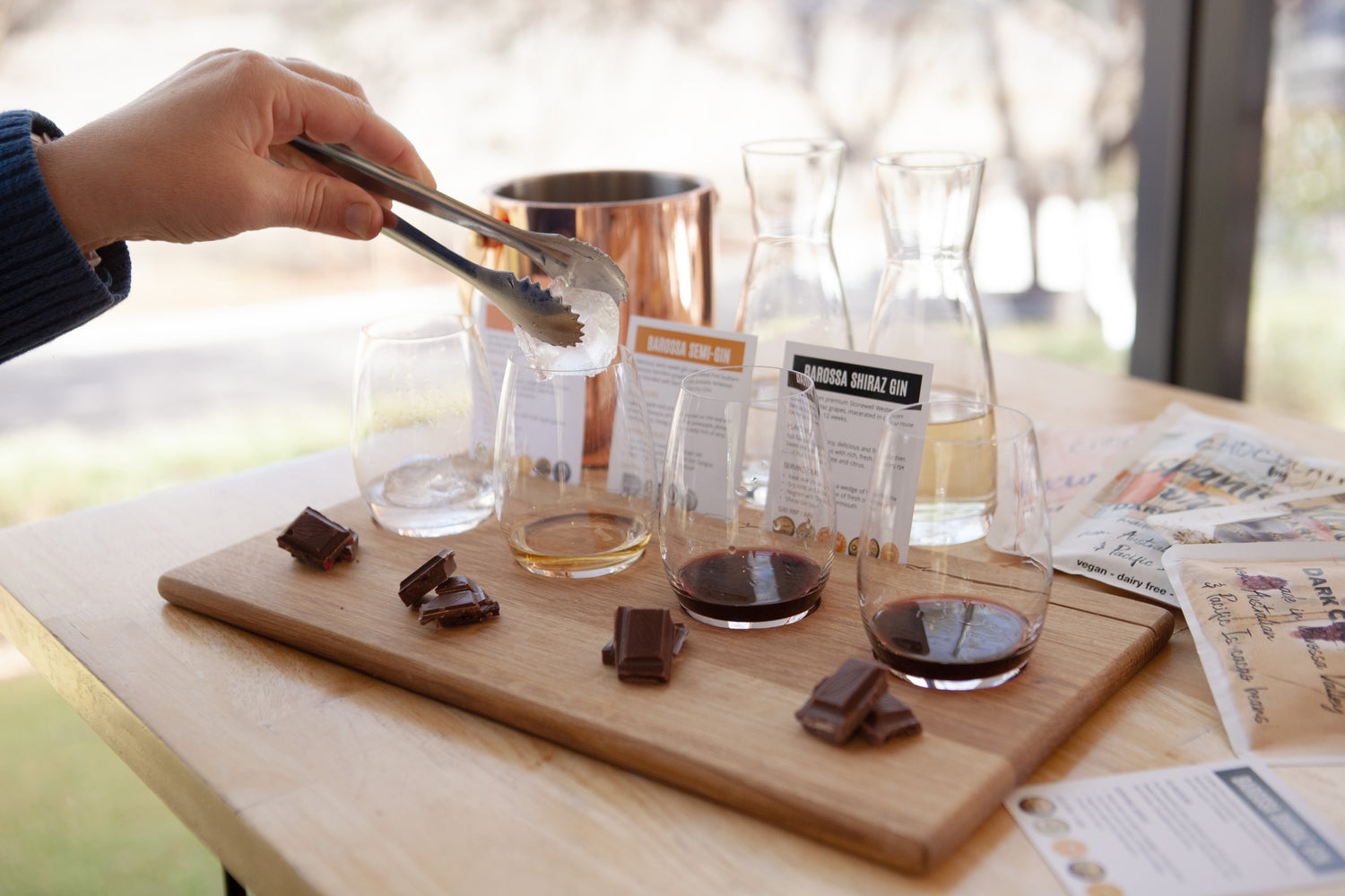 Person enjoying a gin and chocolate tasting flight 